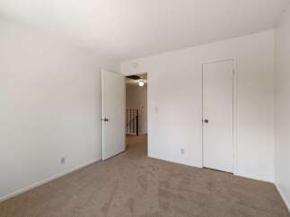 Step into this inviting room featuring plush carpeting and clean white walls, creating a serene atmosphere.