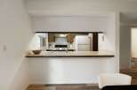 Discover this charming kitchen featuring a convenient pass-through window, perfect for entertaining guests.