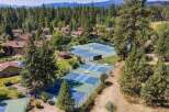 Experience resort-style living with this aerial view showcasing multiple tennis and pickleball courts, perfect for active residents.