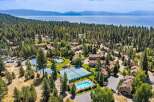 Discover this stunning property nestled amidst a lush pine forest, offering breathtaking views of a serene lake and distant mountains.