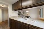 Discover this charming kitchen featuring a spacious sink and ample counter space, perfect for meal preparation.