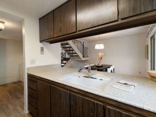 Discover this charming kitchen featuring a spacious sink and ample counter space, perfect for meal preparation.