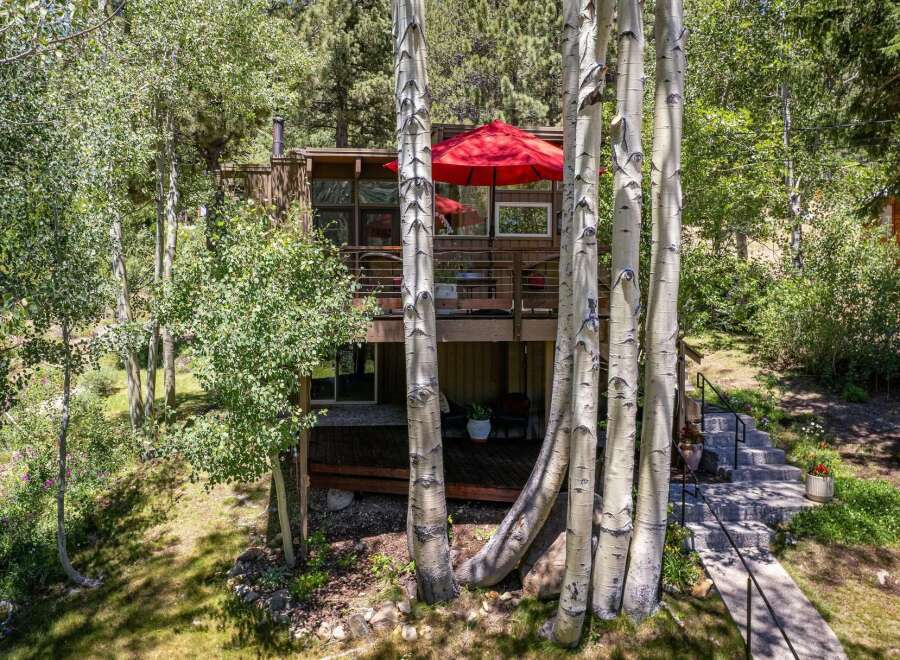 Nestled amongst mature aspen trees, this charming home offers a serene mountain retreat.