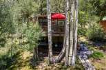 Nestled amongst mature aspen trees, this charming home offers a serene mountain retreat.