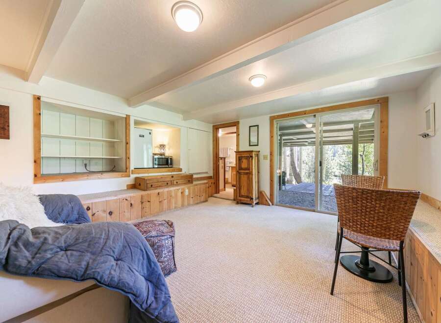 Discover comfortable living in this inviting space, featuring built-in wooden seating and shelving for a cozy, functional atmosphere.