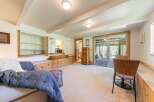 Discover comfortable living in this inviting space, featuring built-in wooden seating and shelving for a cozy, functional atmosphere.