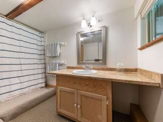 This charming bathroom features a convenient vanity with ample counter space and storage, perfect for everyday use.