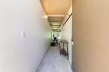 Step into this charming hallway, featuring a neutral carpet and a convenient wall-mounted coat rack.