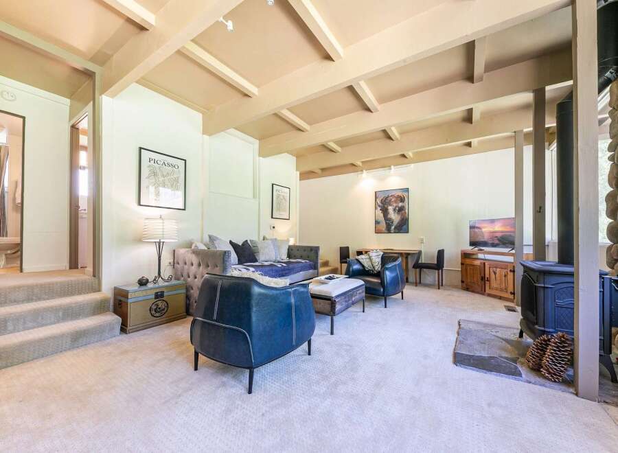 Discover this inviting living space featuring a cozy seating area with plush sofas and armchairs, perfect for relaxation.