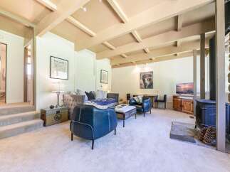 Discover this inviting living space featuring a cozy seating area with plush sofas and armchairs, perfect for relaxation.