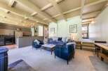 Experience modern living in this spacious open-concept home, featuring a stylish living area with comfortable seating and a striking Picasso-inspired art piece.