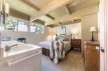 This charming bedroom features a cozy queen-size bed adorned with a luxurious faux fur throw, perfect for relaxing evenings.