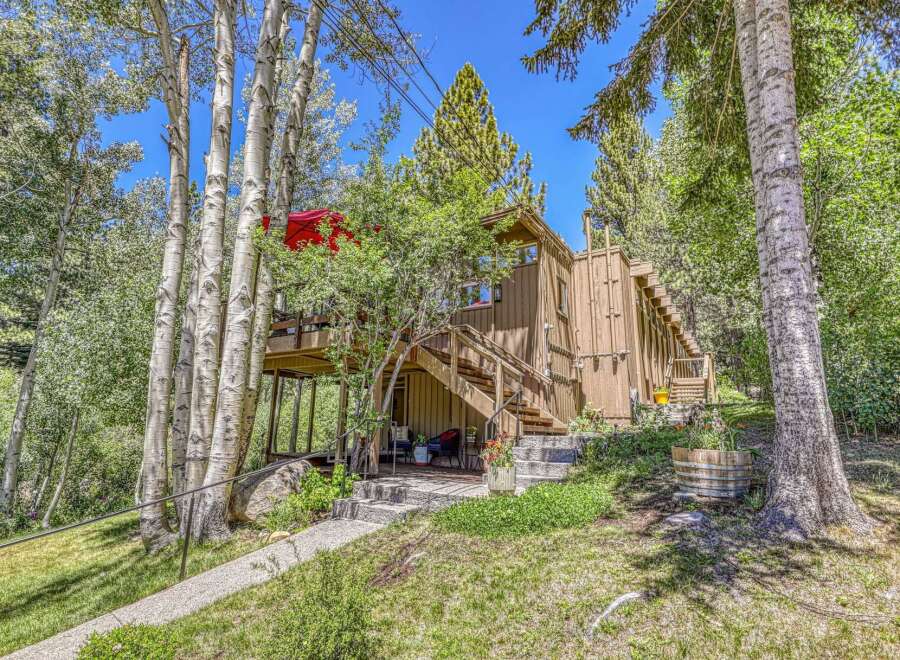 Nestled amongst mature aspen and pine trees, this charming cabin offers a serene mountain retreat.