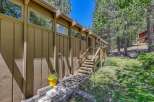 Nestled amongst tall pine trees, this charming home offers a serene mountain retreat.