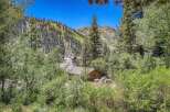 Nestled amidst a lush forest, this charming property offers a serene mountain retreat.