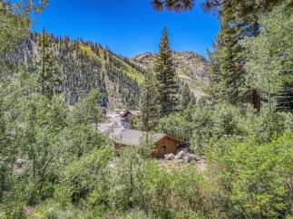 Nestled amidst a lush forest, this charming property offers a serene mountain retreat.