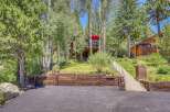 Nestled amongst mature trees, this charming mountain home offers a serene retreat.