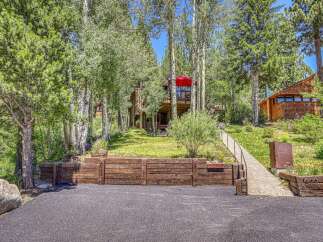 Nestled amongst mature trees, this charming mountain home offers a serene retreat.