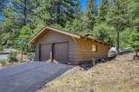 Discover this charming property featuring a rustic wooden garage with double doors, perfect for vehicle storage or a workshop.