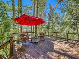 Enjoy the serene mountain views from this charming deck, perfect for outdoor relaxation.
