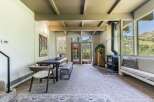 Experience breathtaking mountain views from this stunning property, featuring a cozy living area with a wood-burning stove and a spacious dining area perfect for gatherings.