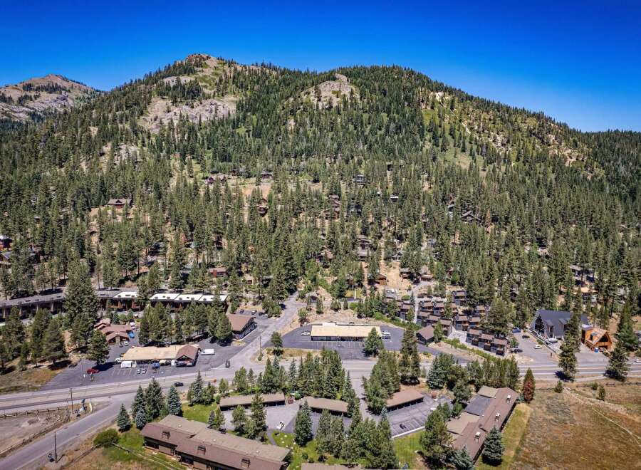 Nestled amidst a dense forest and rolling hills, this property offers a serene mountain retreat.