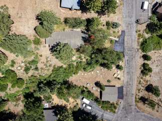 Discover this expansive property featuring a main house with a large, flat roof and a detached garage.