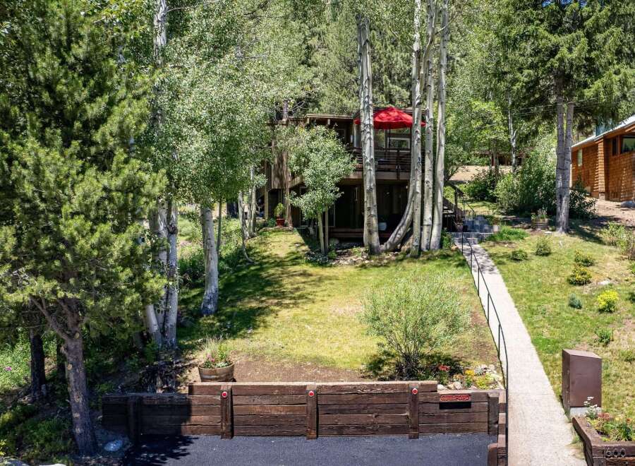 Nestled amongst mature trees, this charming home offers a serene mountain retreat.