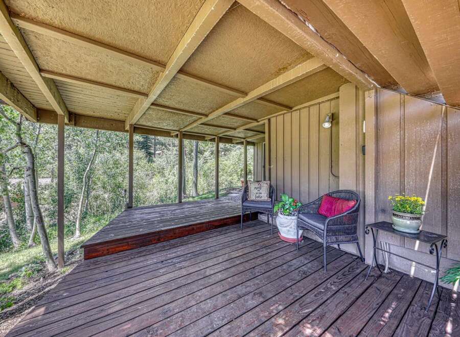 Enjoy the serene mountain views from this charming covered deck, perfect for relaxing or entertaining.