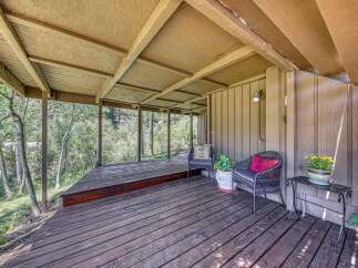 Enjoy the serene mountain views from this charming covered deck, perfect for relaxing or entertaining.