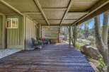 Enjoy the serene mountain setting from this charming covered deck, perfect for relaxing or entertaining.