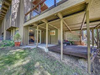 Enjoy outdoor living with this charming property featuring a spacious deck perfect for entertaining or relaxing amidst nature.