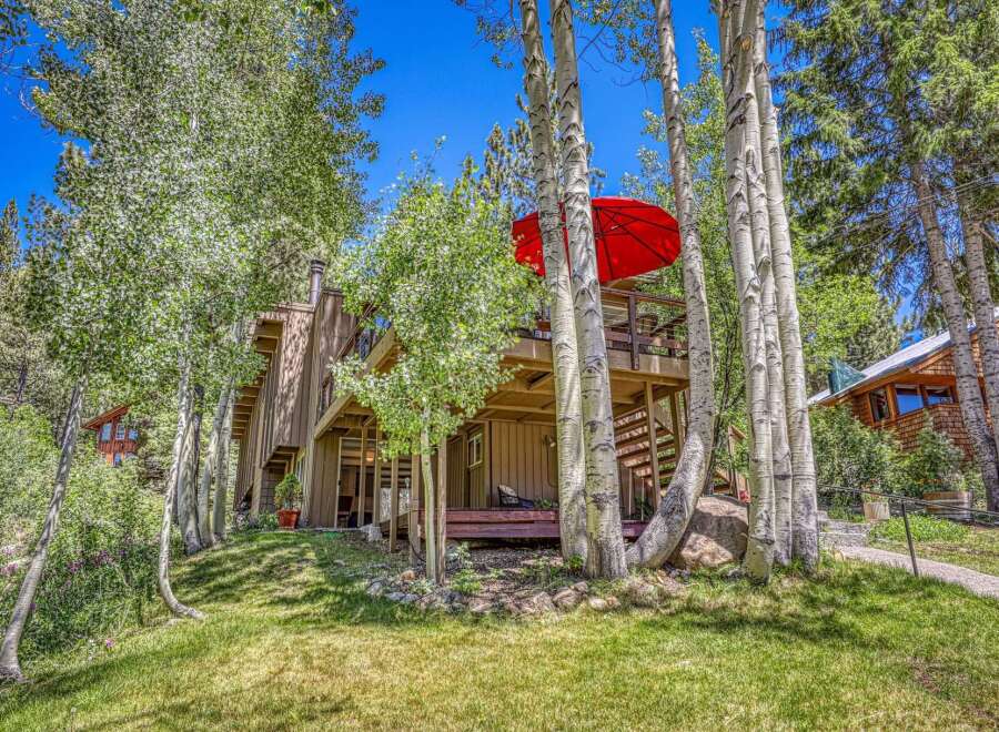 Nestled amongst mature aspen trees, this charming home offers a serene mountain retreat.