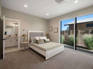 Experience modern comfort in this serene bedroom featuring a plush king-sized bed with a stylish upholstered headboard.