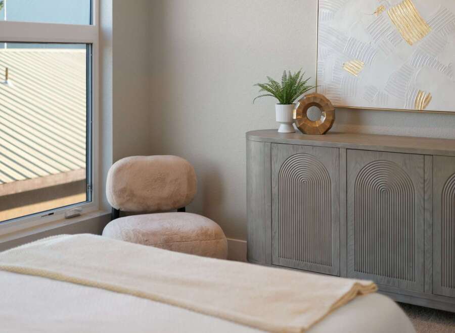 Discover modern comfort in this beautifully appointed bedroom, featuring a plush, textured accent chair perfect for relaxation.