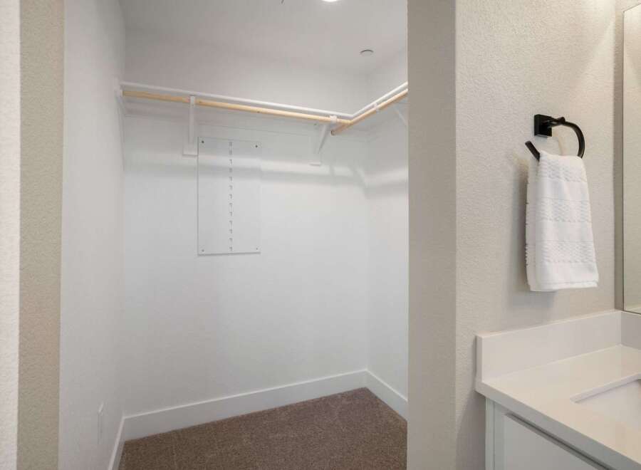Step into this spacious walk-in closet, ready for your personal touch.