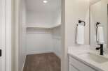 Discover ample storage in this spacious walk-in closet, perfect for organizing your wardrobe.