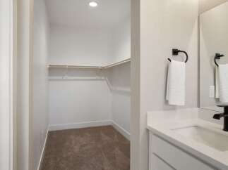 Discover ample storage in this spacious walk-in closet, perfect for organizing your wardrobe.