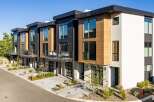 Discover modern living in these stunning townhomes featuring a striking contemporary design with wood and dark paneling accents.