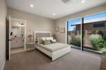 Experience modern comfort in this serene bedroom featuring a plush king-sized bed with a stylish upholstered headboard.