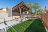 Discover this modern outdoor living space featuring a covered wooden pergola and a built-in seating area, perfect for entertaining.