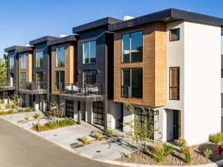 Discover modern living in these stunning townhomes featuring a striking contemporary design with wood and dark paneling accents.