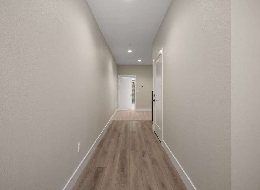 Step into this inviting hallway featuring a neutral color palette and modern finishes.