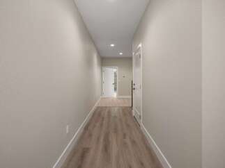 Step into this inviting hallway featuring a neutral color palette and modern finishes.