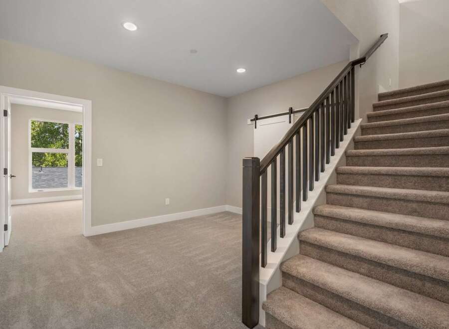 Discover this beautifully appointed home featuring a spacious open-concept living area with plush carpeting and abundant natural light.