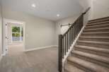 Discover this beautifully appointed home featuring a spacious open-concept living area with plush carpeting and abundant natural light.