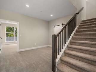 Discover this beautifully appointed home featuring a spacious open-concept living area with plush carpeting and abundant natural light.