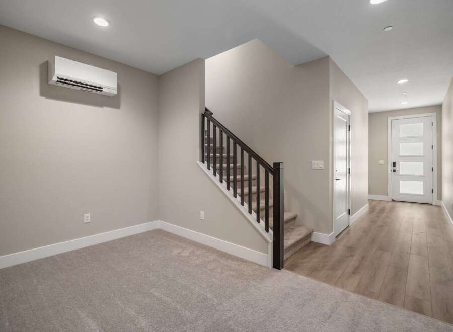 Discover modern living in this spacious home featuring a sleek, wall-mounted air conditioning unit for optimal comfort.