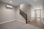 Discover modern living in this spacious home featuring a sleek, wall-mounted air conditioning unit for optimal comfort.