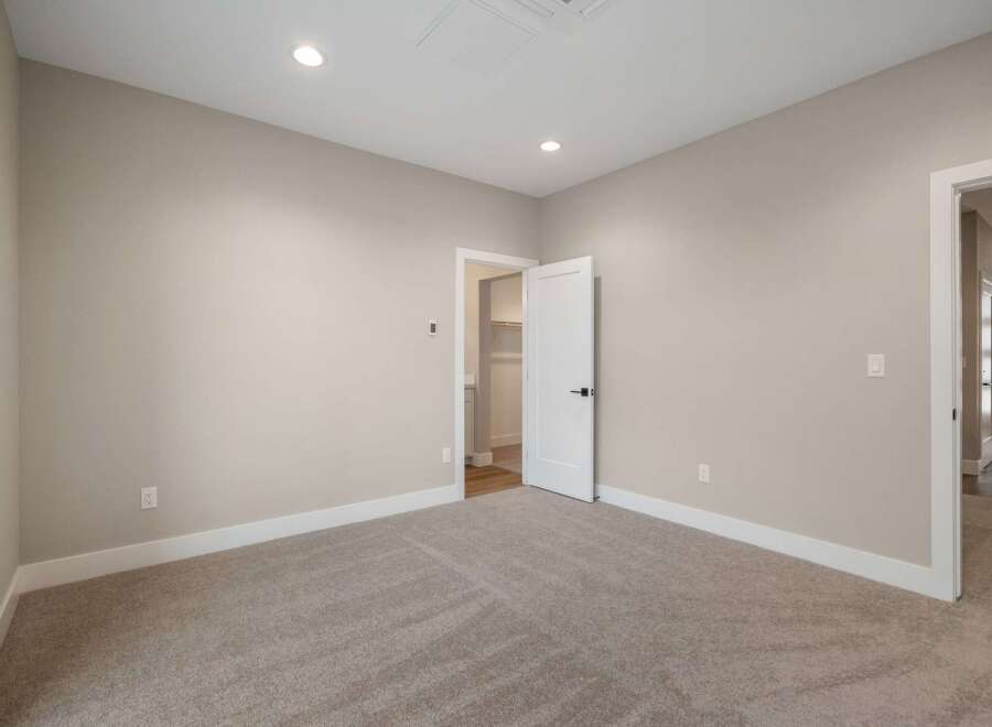 Step into this inviting bedroom, featuring plush carpeting and neutral-toned walls that create a serene atmosphere.